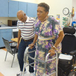 Carolyn Lewis-Carter receives physical therapy to improve her walking at Providence ElderPlace.  She is being assisted by restorative aid Temesgen Haila. Photo/Cynthia Flash. 