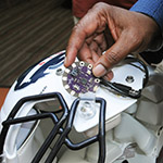 Dr. Gary Harris hopes to improve the way the Howard University Bison football team combats concussion, using this “Lilypad” Arduino chip to measure impact during games. Photo courtesy Howard University.